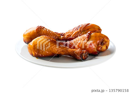barbecue chicken drumsticks on a plate isolated on white background. barbecue chicken drumsticks on a plate isolated on white background. 135790158