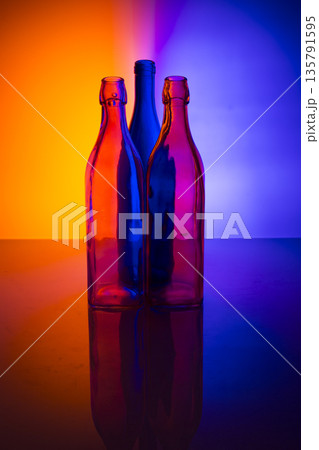 Still life with three bottles against a colored background 135791595