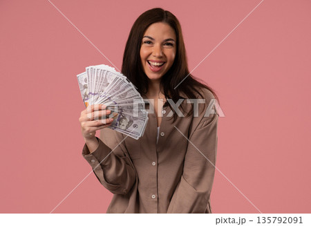Rich Happy Woman Waving Usd Cash Money Dollars As Fan On Pink, Income Payment 135792091