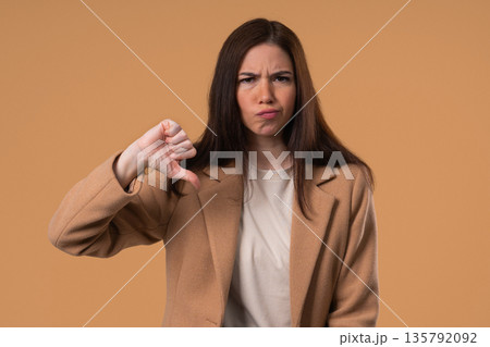 Businesswoman With Sign Of Dislike. Grimacing Student Lady Showing Thumbs-Down 135792092