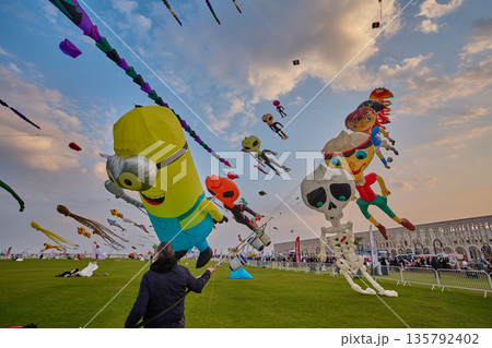 Doha, Qatar - January 20 2026: Qatar Kite Festival 2026 in Old Doha port (Mina District) sunset shot showing spectacular showcase of colorful kites soaring across the picturesque Doha skyline. Doha, Qatar - January 20 2026: Qatar Kite Festival 2026 in Old Doha port (Mina District) sunset shot showing spectacular showcase of colorful kites soaring across the picturesque Doha skyline. 135792402