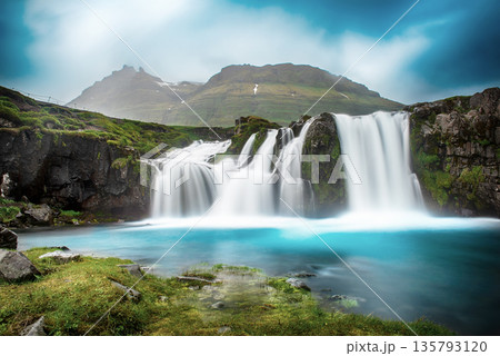 View to the Kirkjufell waterfall at summer. Kirkjufellsfoss waterfall, Iceland, Europe. 135793120