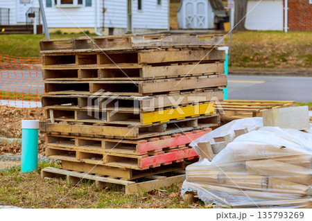 Stack of wooden pallets pile of bricks near construction site in suburban area Stack of wooden pallets pile of bricks near construction site in suburban area 135793269