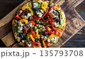 Vibrant Mediterranean flatbread pizza sliced on rustic board 135793708