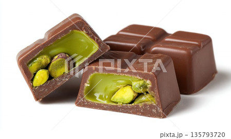 Dark chocolate pieces revealing vibrant pistachio filling Dark chocolate pieces revealing vibrant pistachio filling 135793720