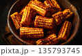 Spicy grilled corn cobs piled in rustic bowl 135793745