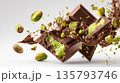 Chocolate bars bursting with pistachio filling and flying nuts 135793746