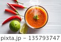 Steaming spicy Thai soup is served with fresh chili and lime 135793747