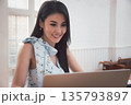 Young asian woman in smart casual wear working with laptop in home office. 135793897