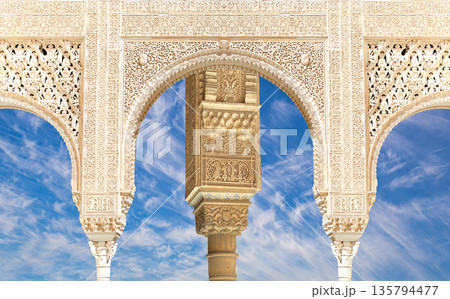 Arches in Islamic (Moorish) style (against the background of a beautiful sky with clouds) in Alhambra, Granada, Spain 135794477