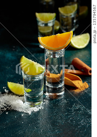 Tequila shots on a black background. 135794567