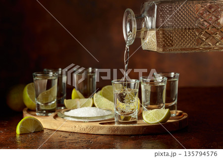 Gold tequila with salt and lime slices. 135794576