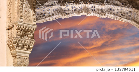 Arches in Islamic (Moorish) style (against the sunset) in Alhambra, Granada, Spain  135794611