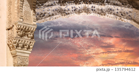 Arches in Islamic (Moorish) style (against the sunset) in Alhambra, Granada, Spain  135794612
