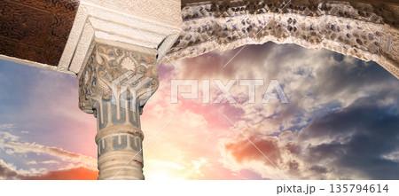 Arches in Islamic (Moorish) style (against the sunset) in Alhambra, Granada, Spain  135794614