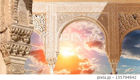 Arches in Islamic (Moorish) style (against the sunset) in Alhambra, Granada, Spain  135794642