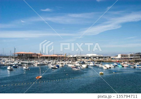 A large body of water with many boats floating on it A large body of water with many boats floating on it 135794711