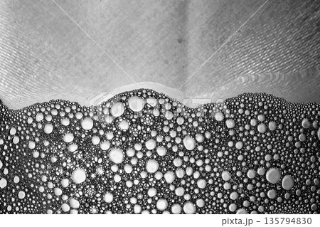 Black and white liquid foam with dense bubbles, abstract macro surface. Black and white liquid foam with dense bubbles, abstract macro surface. 135794830
