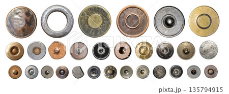 Assortment of metal rivets, buttons, and snaps on transparent background 135794915