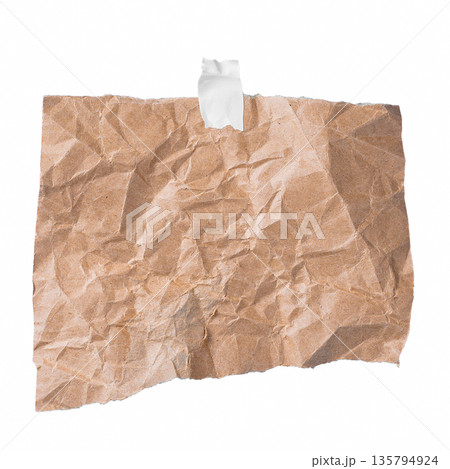 A highly crumpled and torn piece of brown craft paper with a piece of masking tape attached. Evokes vintage, grunge, or rustic themes. 135794924