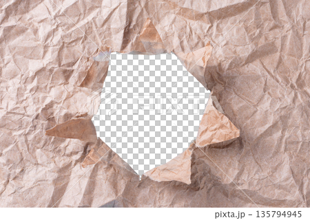 A natural, rough torn hole in a piece of brown craft paper, revealing the background. A versatile design element for grunge or rustic themes. On a transparent background. A natural, rough torn hole in a piece of brown craft paper, revealing the background. A versatile design element for grunge or rustic themes. On a transparent background. 135794945