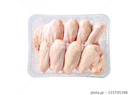raw chicken wings in a plastic container isolated on a white background, top view. raw chicken wings in a plastic container isolated on a white background, top view. 135795396