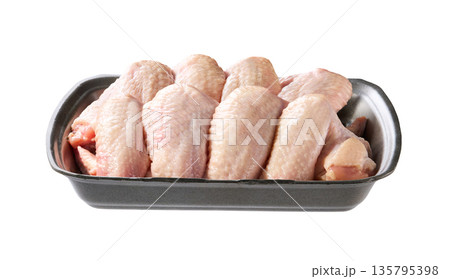 raw chicken wings in a plastic container isolated on a white background. raw chicken wings in a plastic container isolated on a white background. 135795398