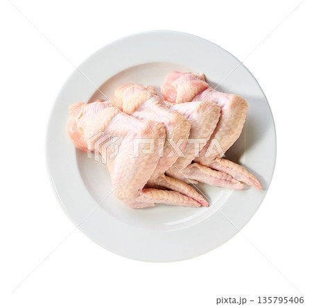 raw chicken wings on a plate isolated on a white background, top view. 135795406