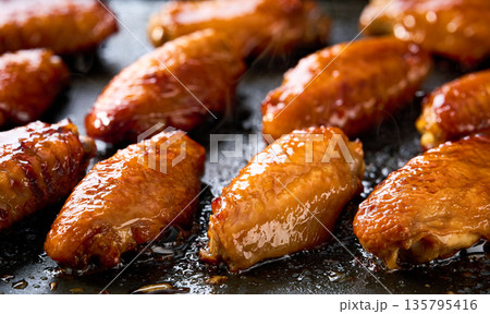 barbecuing tasty chicken wings .roasted chicken wings on a grill. barbecuing tasty chicken wings .roasted chicken wings on a grill. 135795416