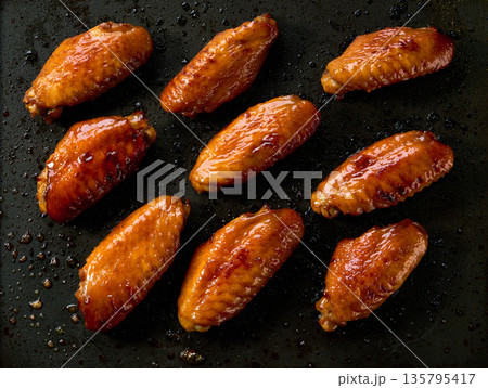 cooking chicken wings in a grill, top view. BBQ chicken wings on a grill. roasted chicken wings on a grill, top view. cooking chicken wings in a grill, top view. BBQ chicken wings on a grill. roasted chicken wings on a grill, top view. 135795417