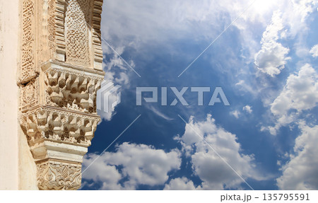 Columns in Islamic (Moorish)  style in Alhambra (against the background of a beautiful sky with clouds), Granada, Spain 135795591