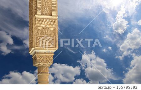 Columns in Islamic (Moorish) style in Alhambra (against the background of a beautiful sky with clouds), Granada, Spain Columns in Islamic (Moorish) style in Alhambra (against the background of a beautiful sky with clouds), Granada, Spain 135795592