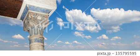 Columns in Islamic (Moorish)  style in Alhambra (against the background of a beautiful sky with clouds), Granada, Spain 135795595