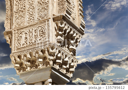 Columns in Islamic (Moorish)  style in Alhambra (against the background of a beautiful sky with clouds), Granada, Spain 135795612