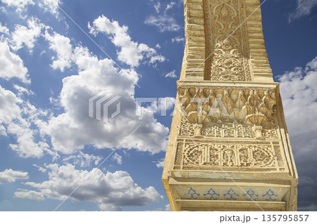 Columns in Islamic (Moorish)  style in Alhambra (against the background of a beautiful sky with clouds), Granada, Spain 135795857