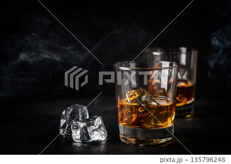 Whiskey with ice in glasses Whiskey with ice in glasses 135796248