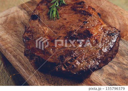 grilled steak, beef steak, rib eye steak, on a chopping board, top view, no people grilled steak, beef steak, rib eye steak, on a chopping board, top view, no people 135796379