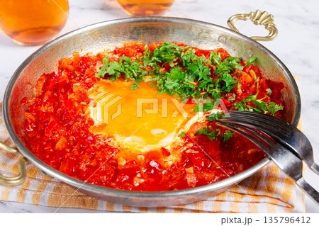 traditional Turkish dish, scrambled eggs with tomatoes, Menemen, with herbs, in a frying pan, close-up, no people, 135796412