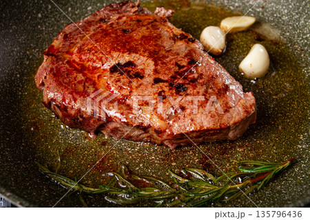 fried steak, beef steak, rib eye steak, in a frying pan, top view, no people fried steak, beef steak, rib eye steak, in a frying pan, top view, no people 135796436