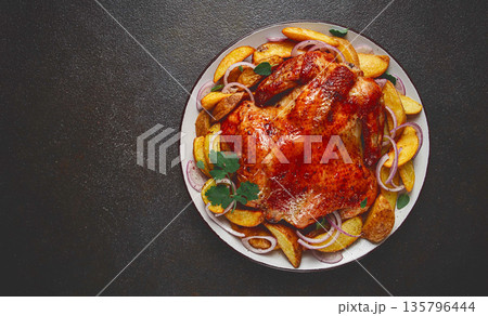 fried, baked chicken, in the oven, with spices, and rustic potatoes, top view, homemade, 135796444