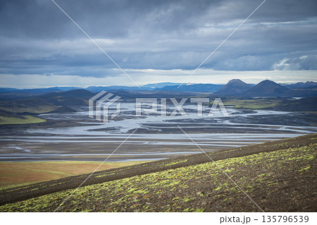 Beautiful volcanic and glacier landscape with thick stormy clouds hanging above, Highlands, Iceland Beautiful volcanic and glacier landscape with thick stormy clouds hanging above, Highlands, Iceland 135796539