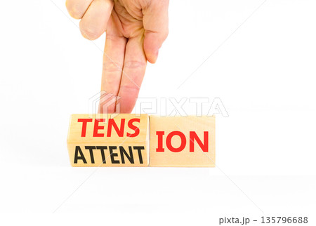 Tension or attention symbol. Concept words Attention or Tension on beautiful wooden blocks. Beautiful white background. Businessman's hand. Business tension or attention concept. Copy space. Tension or attention symbol. Concept words Attention or Tension on beautiful wooden blocks. Beautiful white background. Businessman's hand. Business tension or attention concept. Copy space. 135796688