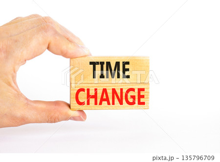Time change symbol. Concept word Time change on beautiful wooden blocks. Beautiful white paper background. Businessman's hand. Business time change concept. Copy space. 135796709