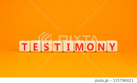 Testimony symbol. Concept word Testimony on beautiful wooden blocks. Beautiful orange background. Business education support testimony concept. Copy space. Testimony symbol. Concept word Testimony on beautiful wooden blocks. Beautiful orange background. Business education support testimony concept. Copy space. 135796821