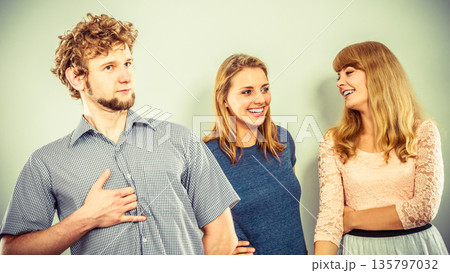 Two women talking gossiping about man. 135797032