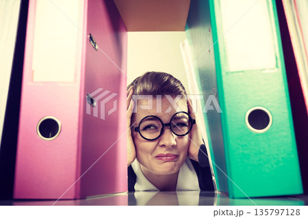 Accountant terrified of pils of binders. 135797128