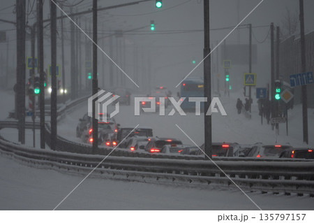 City traffic moving slowly during winter snowstorm blizzard 135797157