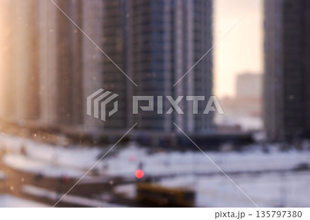 Nighttime urban snow scene, Snowcovered city with warm lights and misty twilight setting 135797380