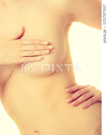 Woman covering her breast with hands 135797507