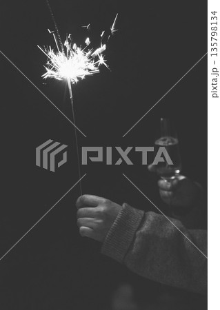 A dramatic low-key shot captures celebration moment. In The Dark trend with stark contrast. Moody, authentic lifestyle aesthetic. Festive party scene. A dramatic low-key shot captures celebration moment. In The Dark trend with stark contrast. Moody, authentic lifestyle aesthetic. Festive party scene. 135798134